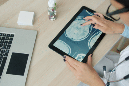 Doctors reviewing medical scans on a tablet.